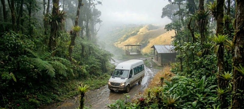 Tourists traveling into a private shuttle van in Costa Rica's rainforest