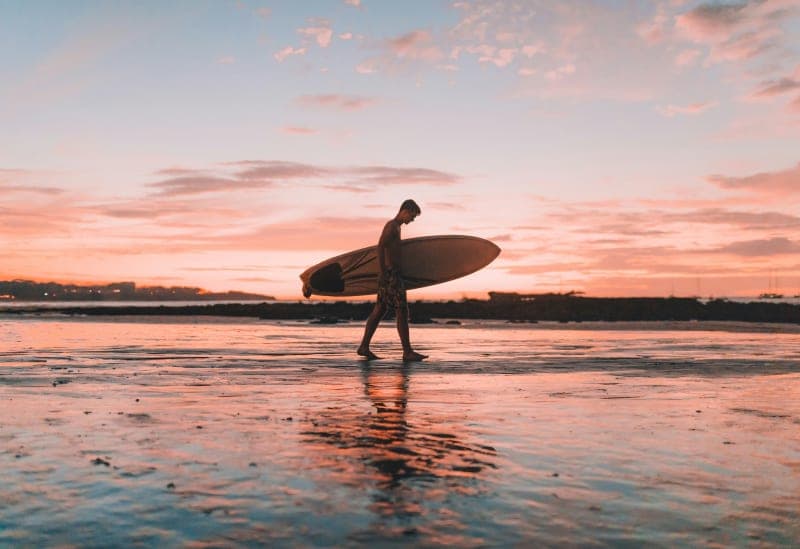 Surfer in Tamarindo Costa Rica sunset